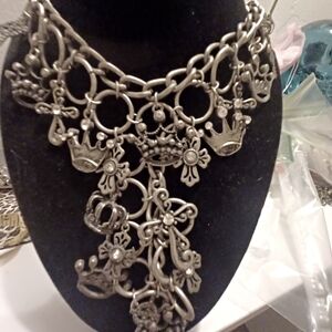 Brilliant bib style featuring crowns and crosses